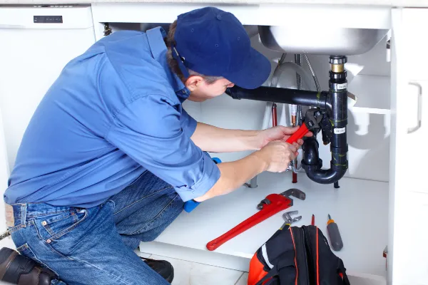 a male plumber fixing a toilet from Quality Plumbing Leander in Leander, TX Plumber near me